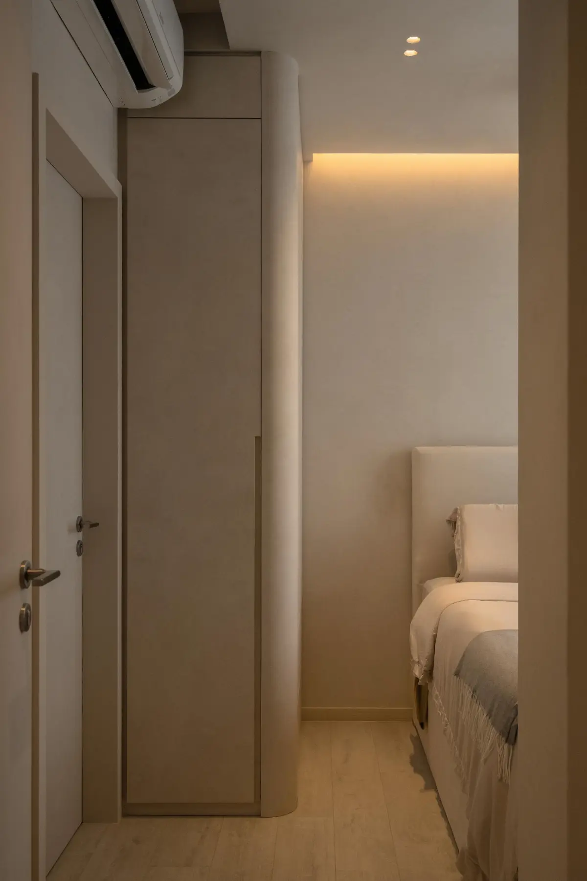 Secondary bedroom entry — corridor view and cove-lit room beyond