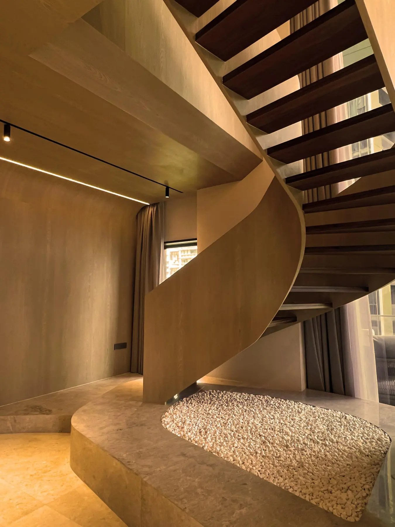 K2SD Oak House — dramatic oculus staircase on sculpted marble platform