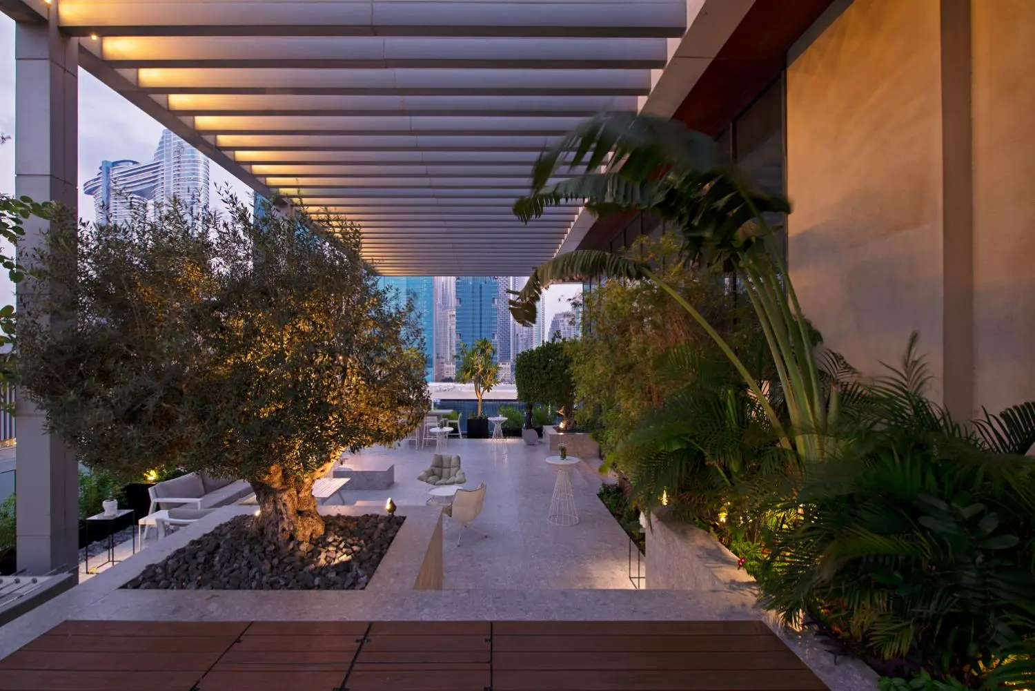 Dori Hitti Architects — outdoor terrace with art pieces and greenery